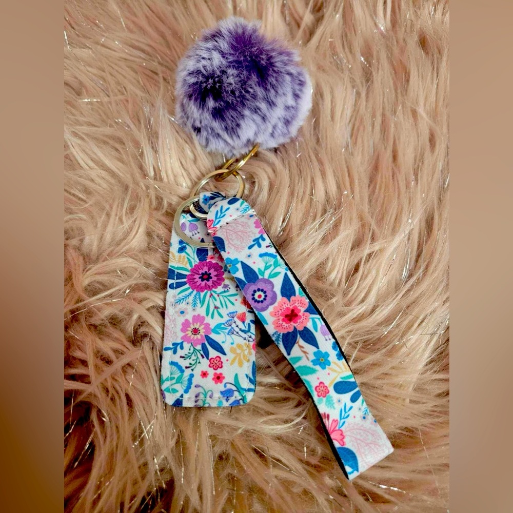 Floral wristlet with chapstick holder and fuzzy ball